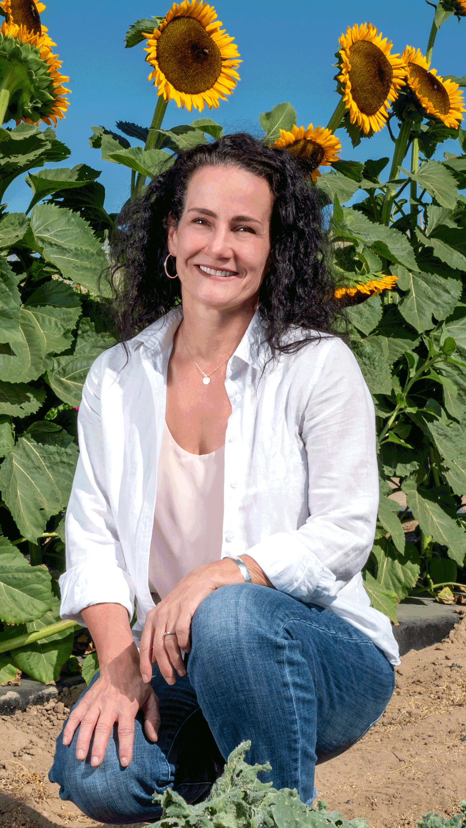 Dr. Turner posing in a sunflower field.